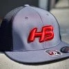 HB Sports Headbanger Sports I8501 Cap America Flexfit Performance Trucker Mesh Back Hat: Graphite / Red 1 HB Sports Headbanger Sports I8501 Cap America Flexfit Performance Trucker Mesh Back Hat: Graphite / Red